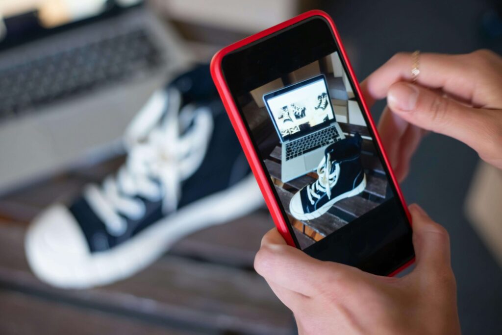 Online seller taking a picture of a shoe they are selling online