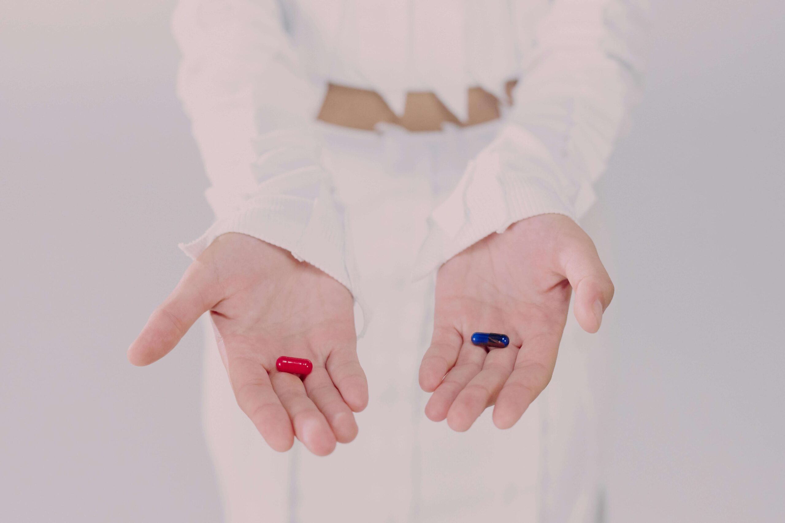 a woman with red and blue pills on her hands 