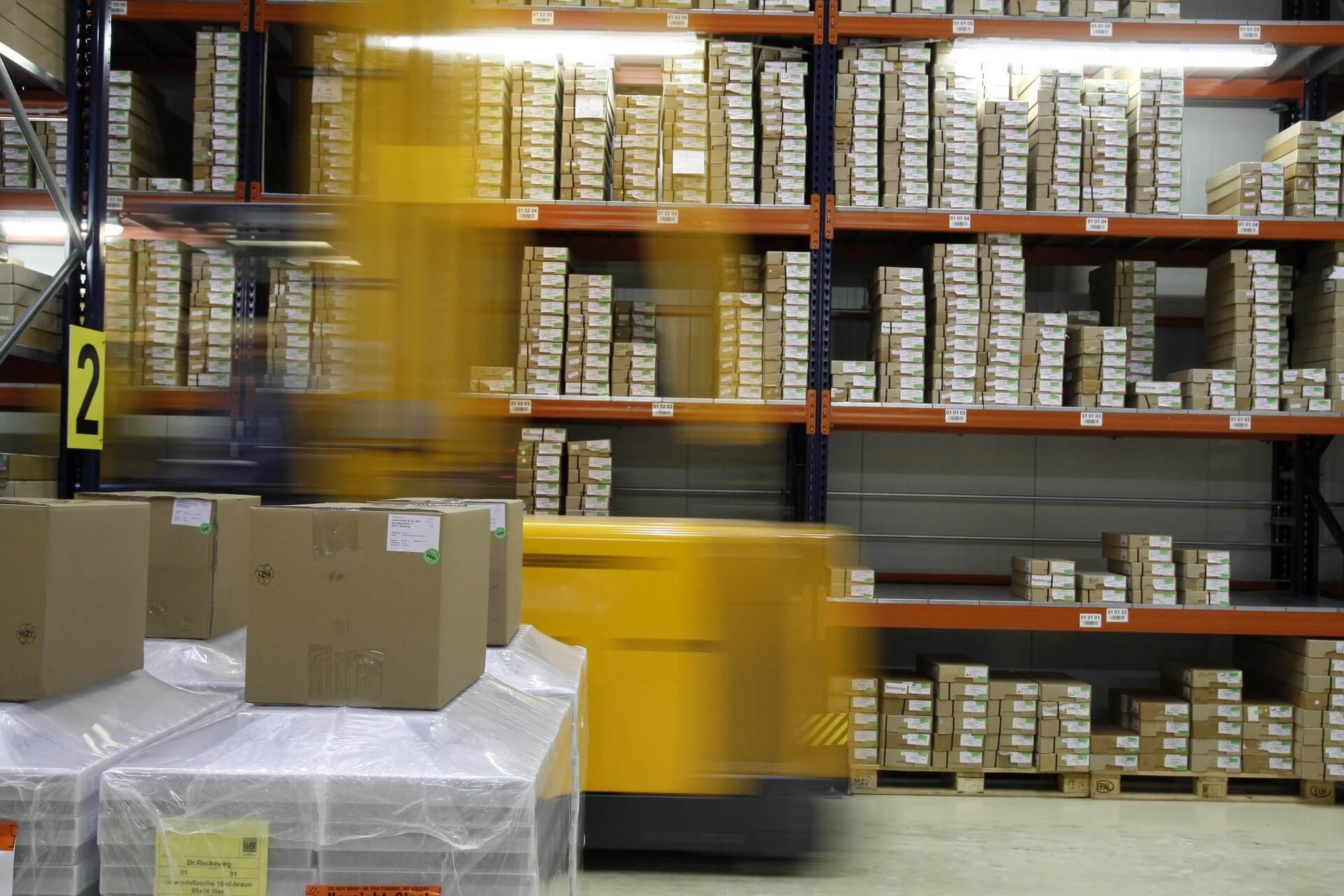 Forklift running swiftly inside a warehouse