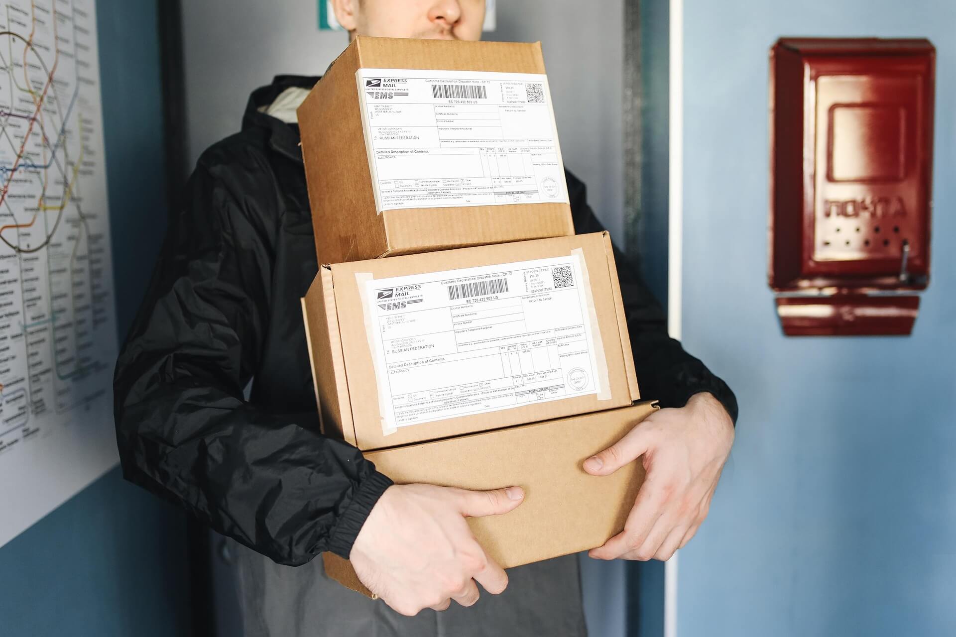 Man carrying three boxes of parcels