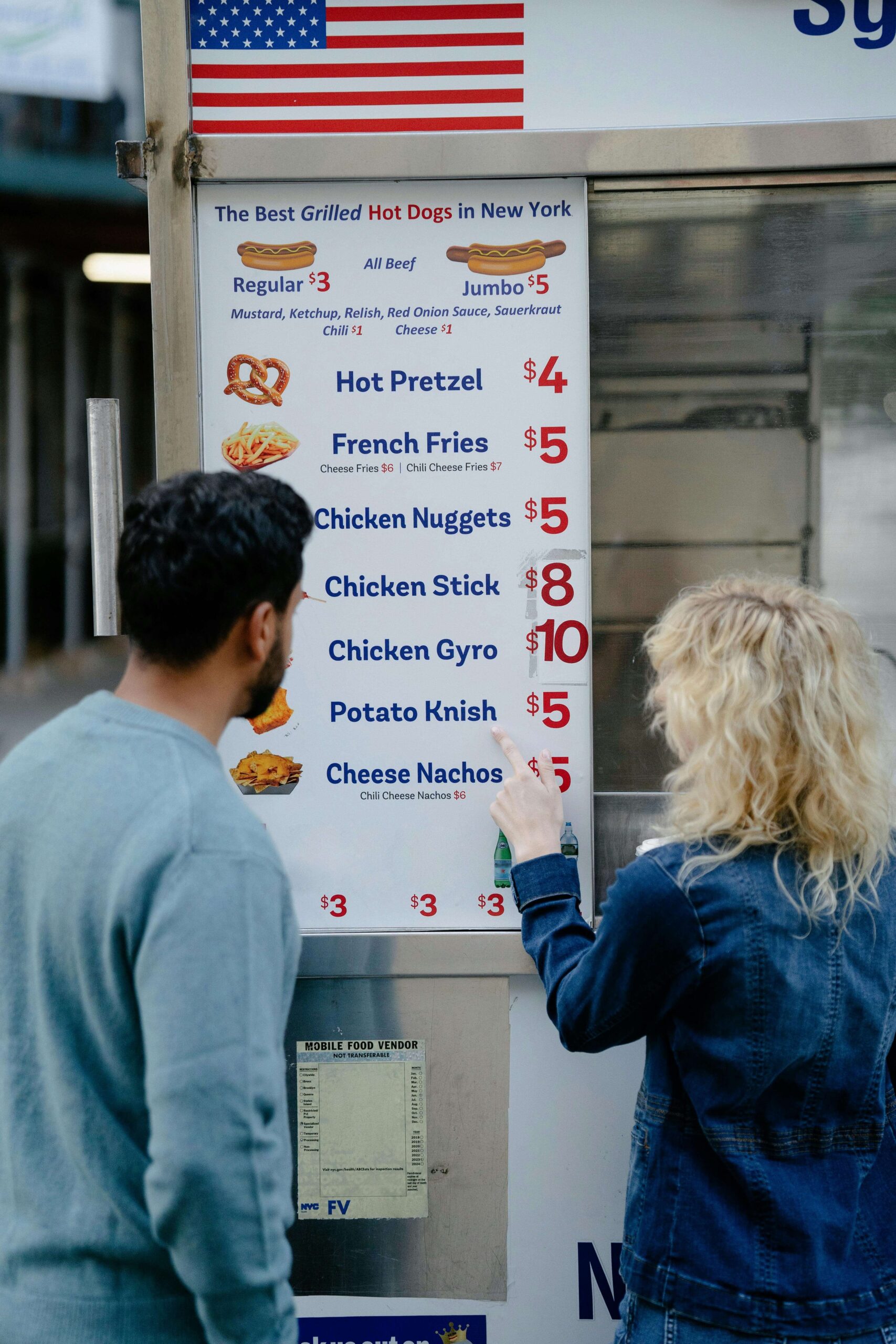 couple looking at price list outside a restaurant