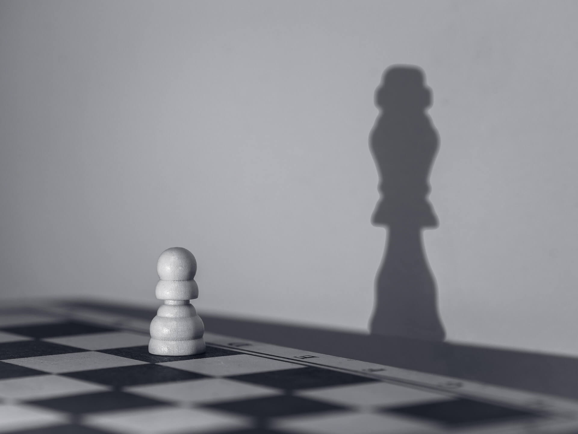 pawn representing business and the queen's shadow on the background representing scaling 
