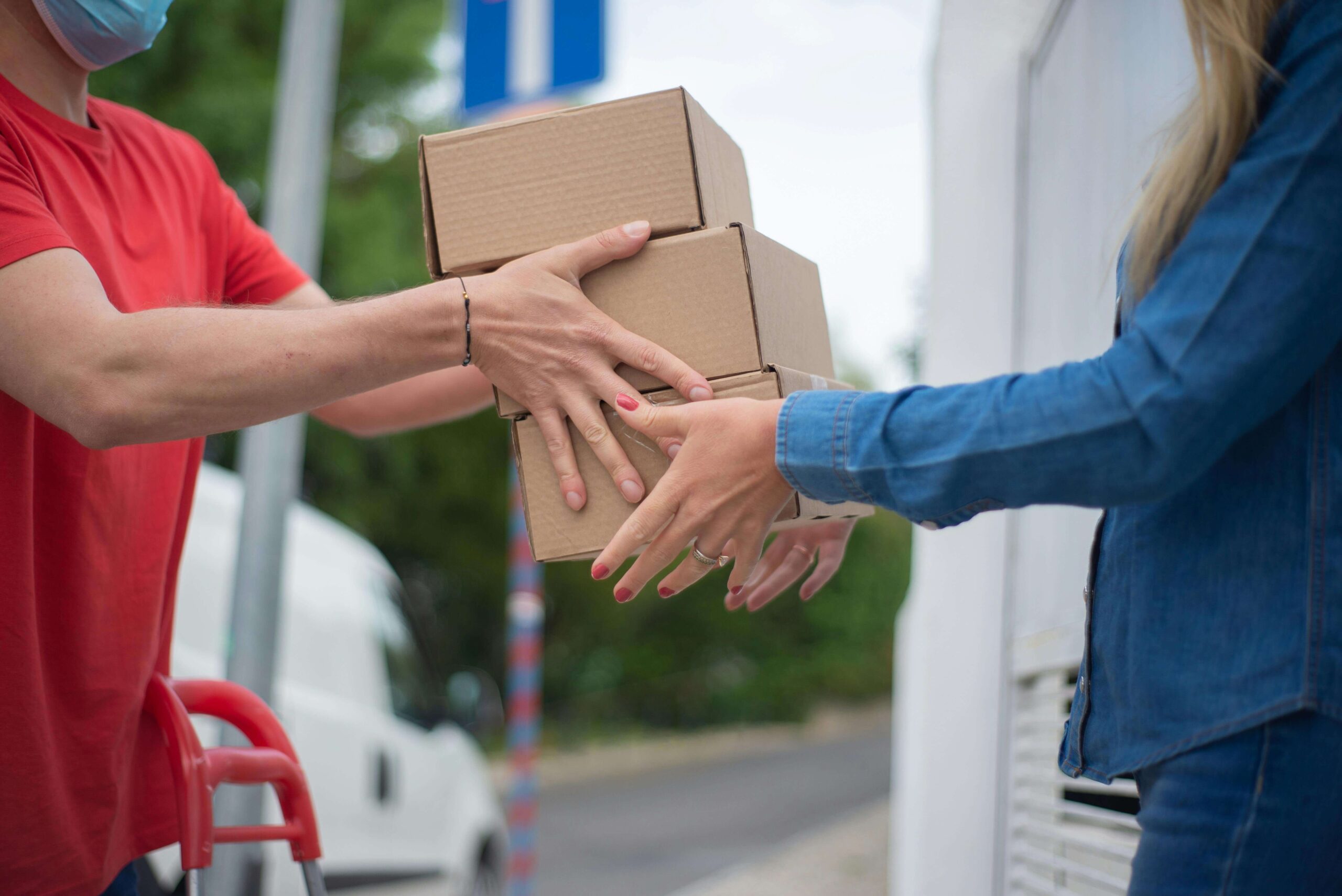 Customer receiving a package from an delivery man