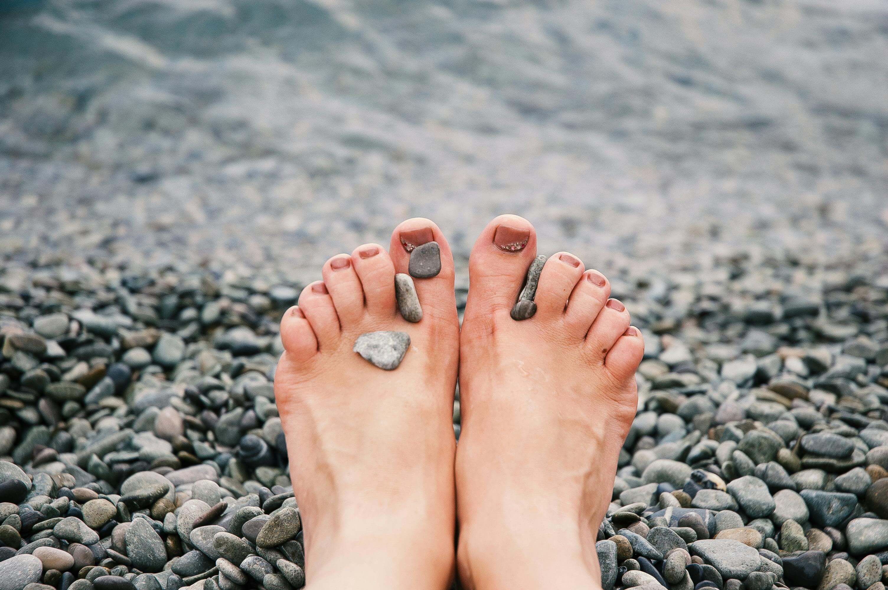 feet and pebbles