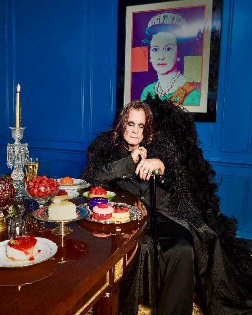 Ozzy Osbourne sitting at the table full of dessert