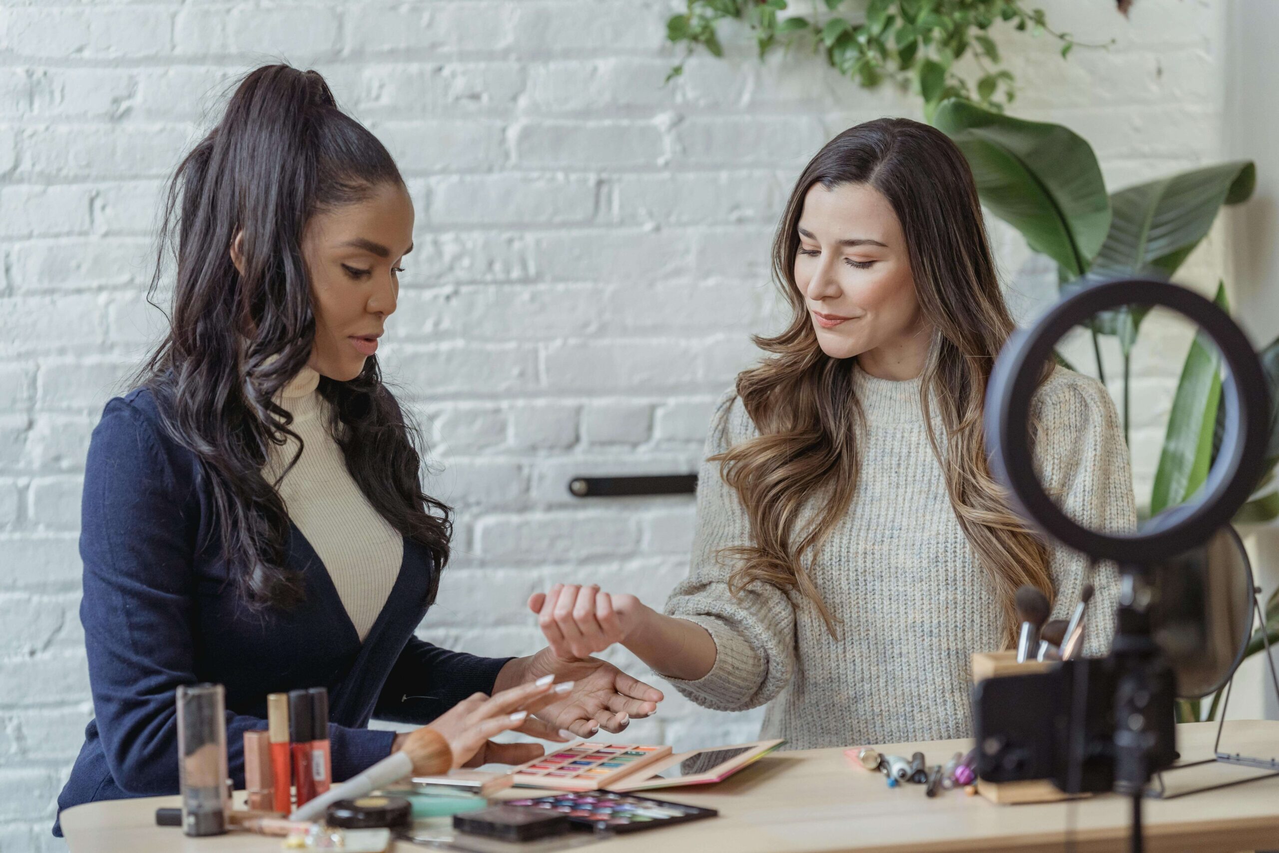 two female online sellers recording a video about their products