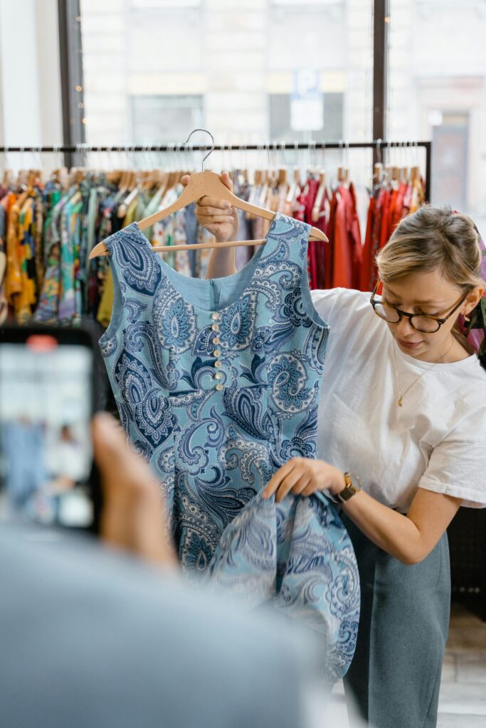 affiliate marketer filming a video of her selling dresses