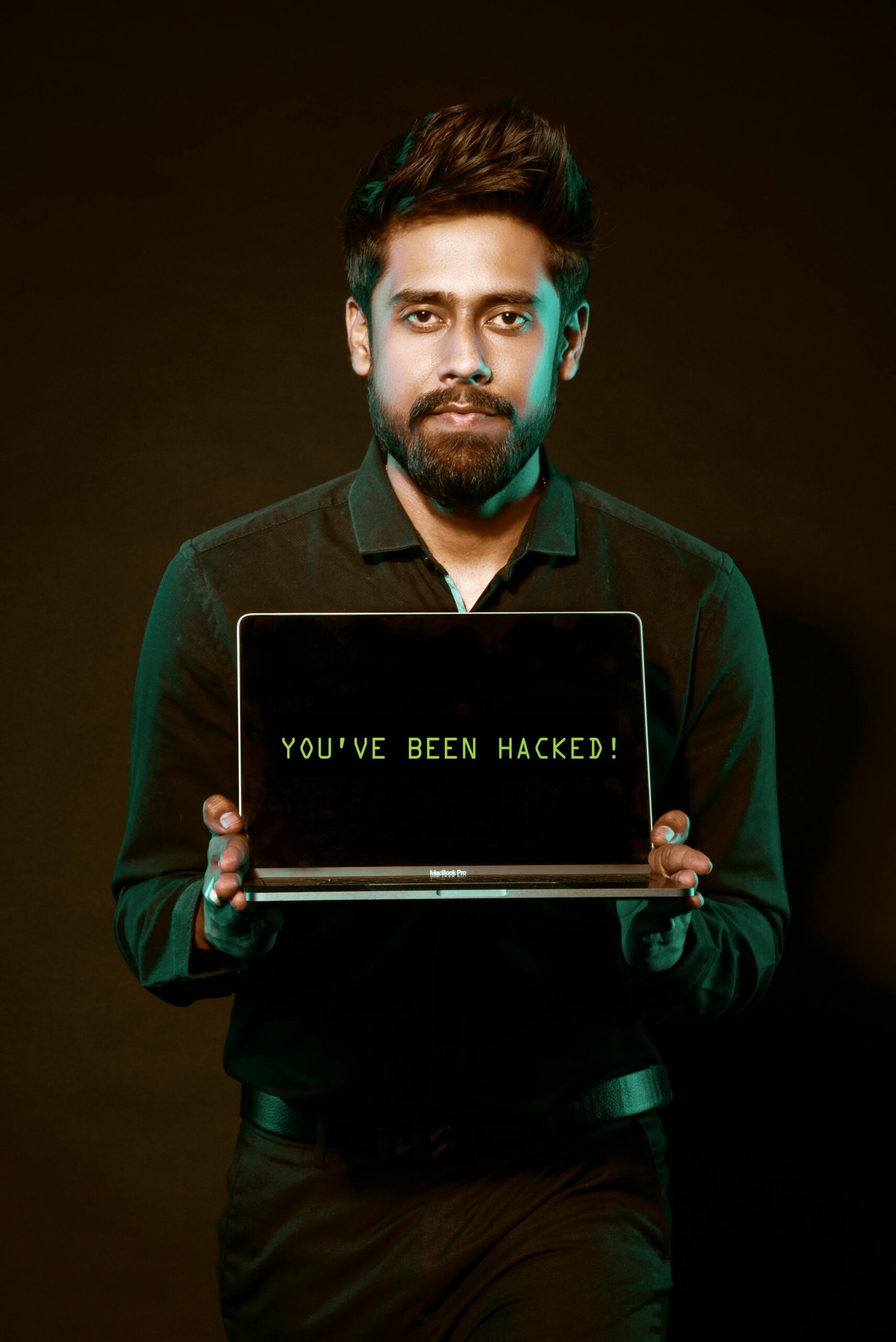 hacker holding up a laptop