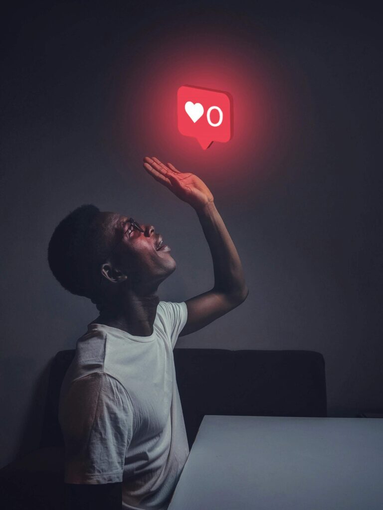 man looking up and above him a floating heart reaction